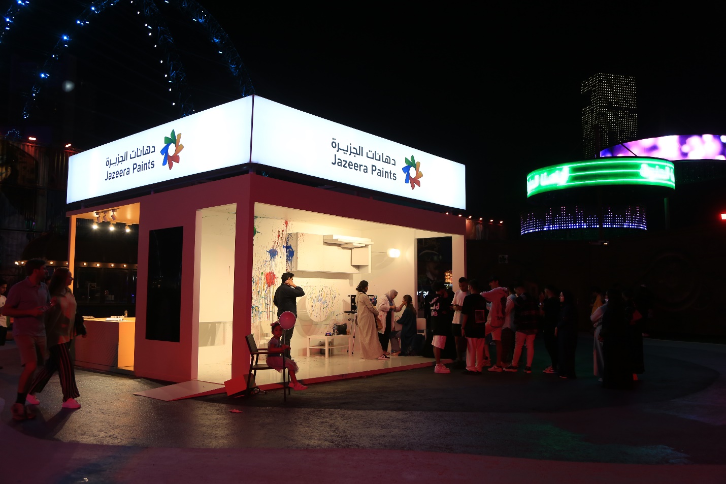 A group of people standing outside a building with neon signs

Description automatically generated with low confidence